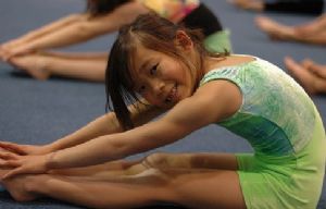 Smiling, Young Girl Stretching